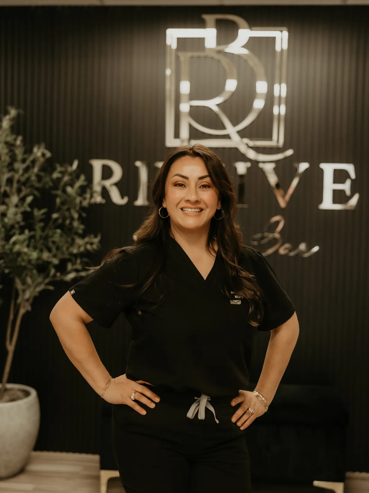 Angelica Alcaraz, BSN, RN, at the Revive Beauty Bar sign in Salinas