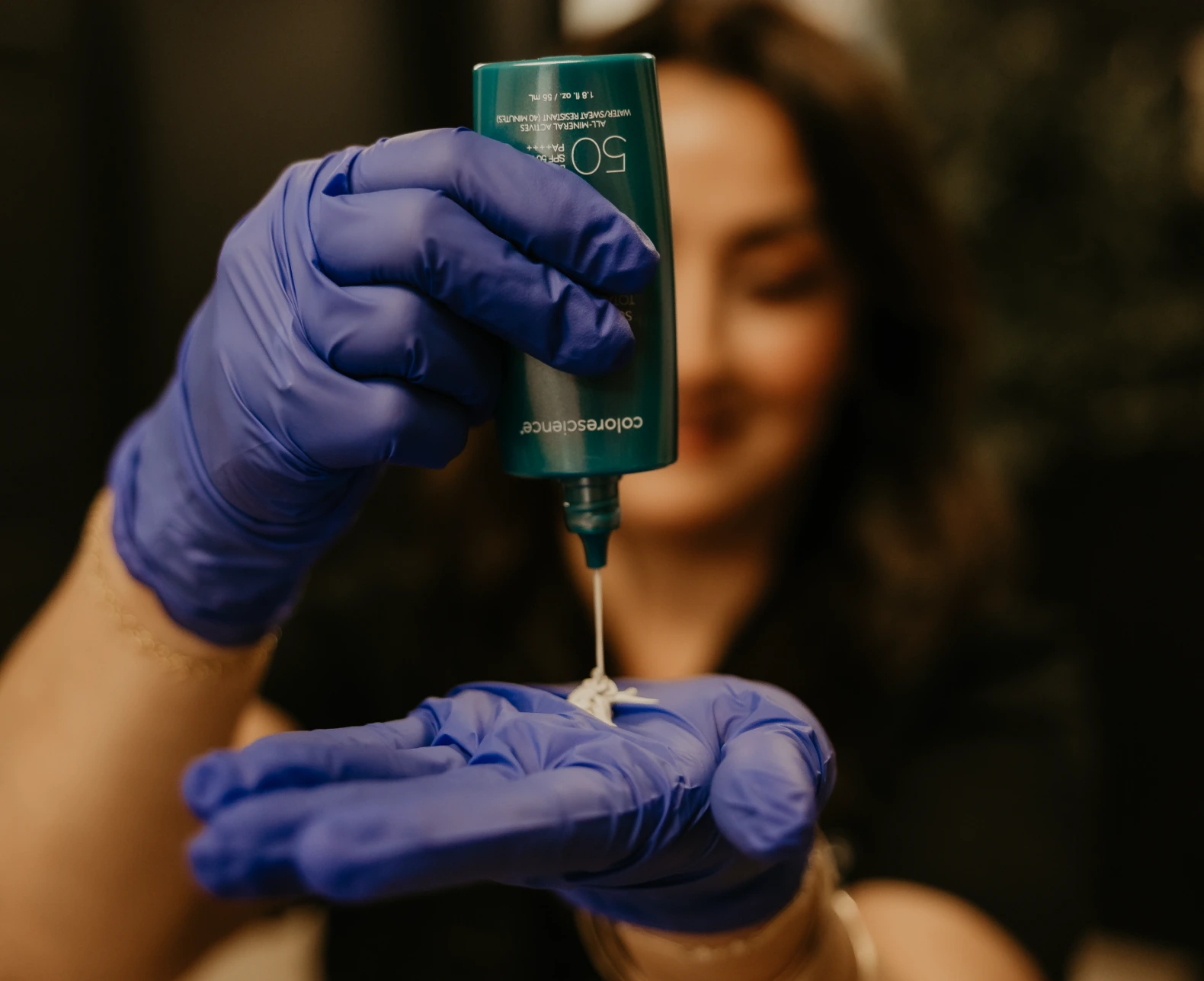 Mineral SPF 50 dispensed into a gloved hand at Revive Beauty Bar